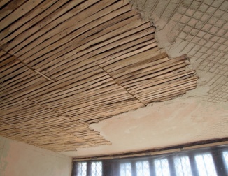 Partially plastered wooden laths