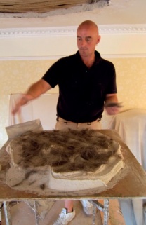 The author adds animal hair to a lime plaster mix
