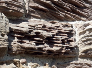 Stone with deep lateral bands of erosion