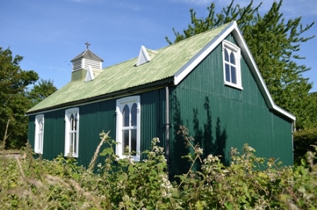 Green painted tin tabernacle with white timber windows and square, louvred bellcote