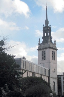 Church tower with louvred windows and elaborate steeple topped by an elongated onion dome