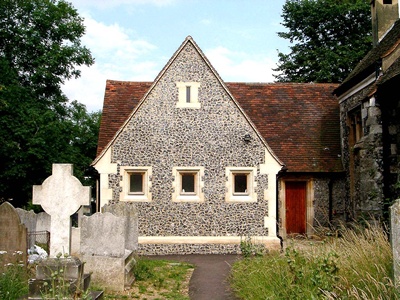 Exterior of church extension sympathetic to existing building in style and materials (knapped flint, ashlar quoins, etc)