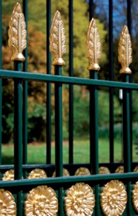 Gate detail with leaf and flower designs picked out in gold