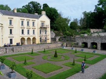 Aberglasney Mansion with the geometric paths and planting of the Cloister Garden in the foreground