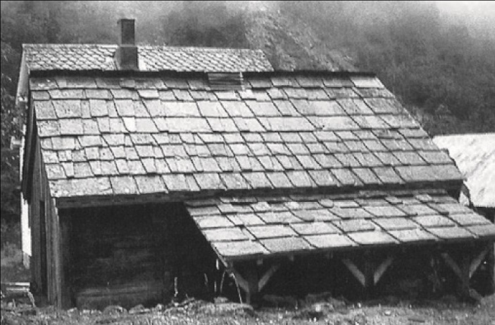 A black and white photo of a house in Sweden with a over-seal slated roof