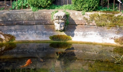 Stone-lined pond with lion's head detail