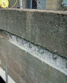 Row of stainless stell cramps fixed into concrete wall