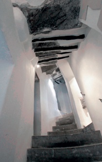 White rendered walls flank a stone staircase