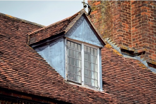 Zinc-faced dormer window in a tiled roof