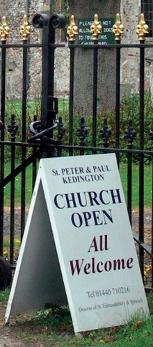A sign outside the church gates reads 'CHURCH OPEN All Welcome'