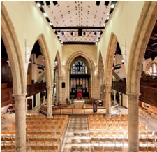 Historic church interior with pews replaced by stackable chairs