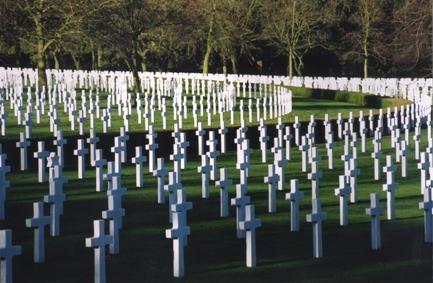 Curving rows of white grave markers in a war cemetery