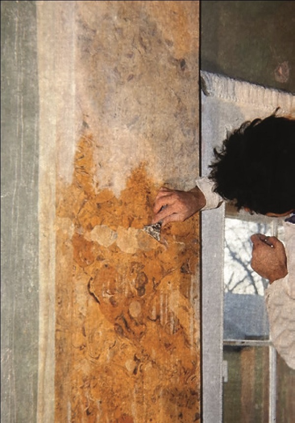 Scagliola being applied by an artist to fill the missing parts on the pilasters