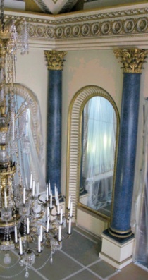 A pair of rich blue scagliola columns with gold capitals