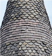 Bands of decorative variation in a slated turret roof