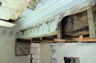Beam encasement with some of its decorative plaster finish removed