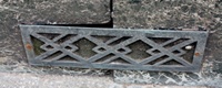 Badly weathered bronze stall-riser vent bearing Art Deco style geometric pattern