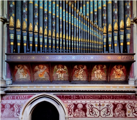 Friezes with Christian subject matter and slogans; vivid blue and gold decorative scheme applied to organ pipes above