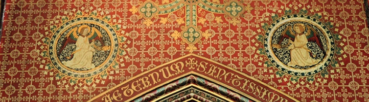 Highly elaborate stencilled decoration including geometric pattern on red background and Latin text