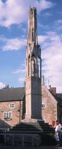 Stone cross at Geddington with canopied statues and hexagonal pinnacle