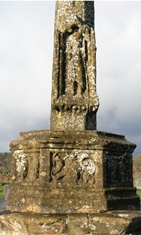 Weather worn and lichen-encrusted stone cross at Bishops Lydeard