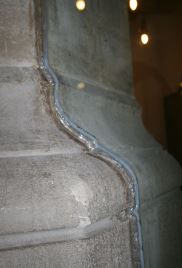 Glass cut to fit snugly against the contours of historic stonework
