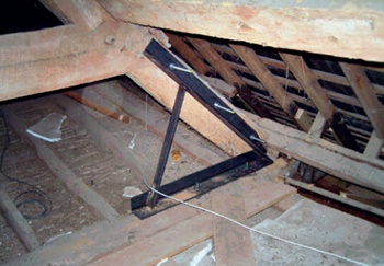 A-shaped angle bracket bolted to truss and beam