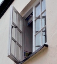 Open casement window with discreet secondary glazing system