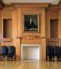 Restored timber-panelled interior of the BBC Council Chamber with portrait of Lord Reith above mantelpiece