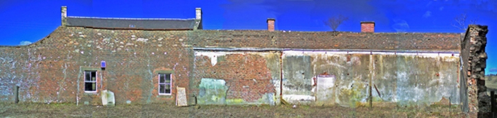 Brick building exterior with areas of harling towards right-hand end