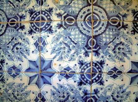 Eight-ponted stars and feathery foliage decorate an area of Delft tile-work