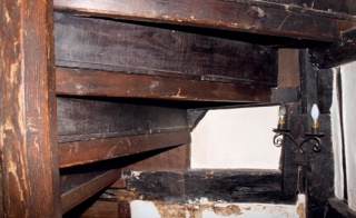 Underside of staircase with horizontal timber supports added beneath treads