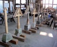 Range of crosses, markers and stone plinths in workshop