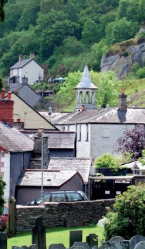View of Corwen with wooded hillside rising in the background