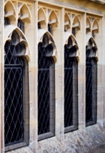 Well integrated window guard recessed behind profile of stone mullions