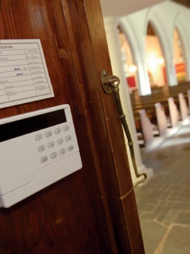 Alarm control panel mounted on church wall