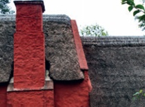 Abutment of two thatched roofs of different heights