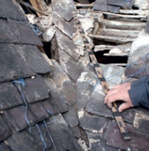 Photograph showing mitred valley of a partially stripped slate roof