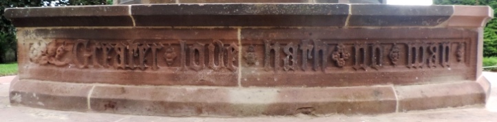 Raised inscription on a repaired sandstone pedestal ('Greater love hath no man')