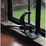 Casement window with iron stanchion and unusual crescent-shaped handle